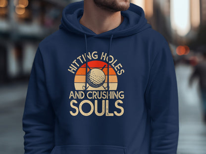 Navy hoodie with "Hitting Holes And Crushing Souls" text and golf ball design.