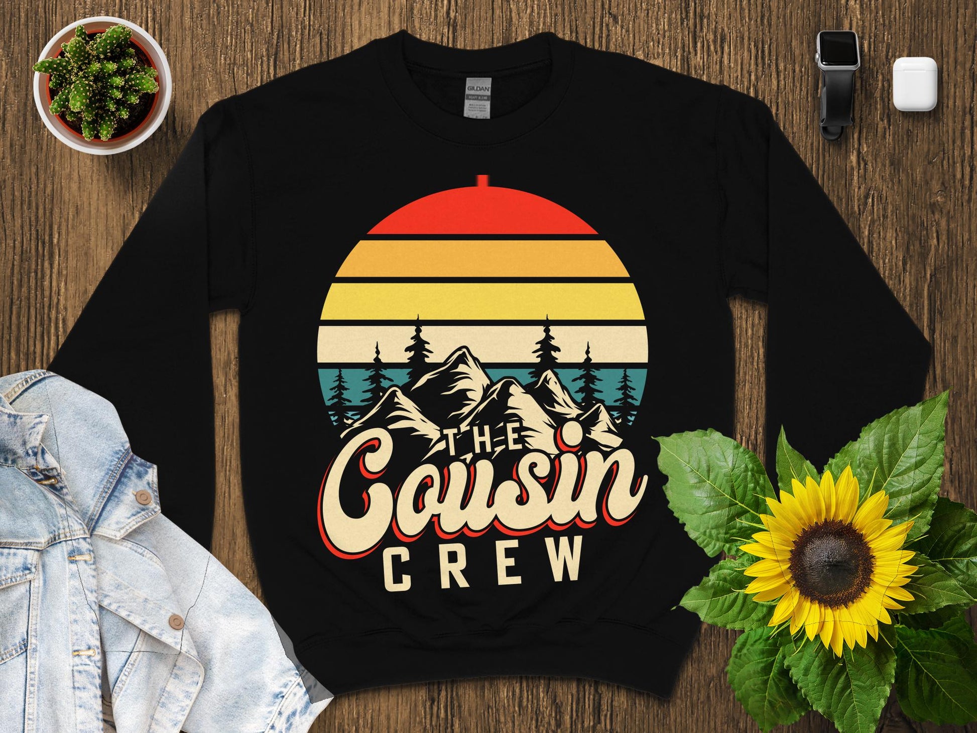 Crewneck sweatshirt with "The Cousin Crew" text and mountain sunset graphic.