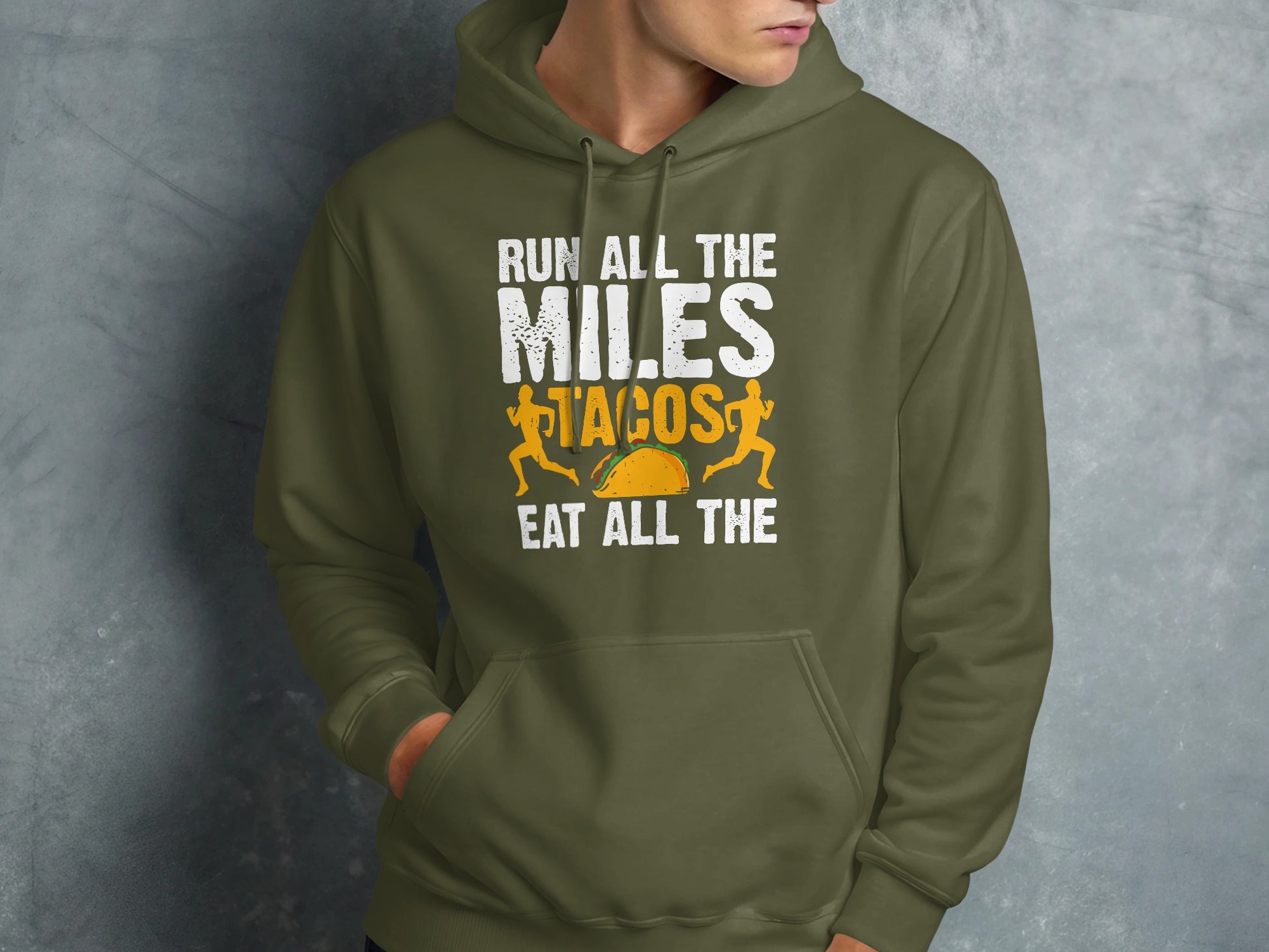 Olive green hoodie with "RUN ALL THE MILES EAT ALL THE TACOS" text and runner graphic.