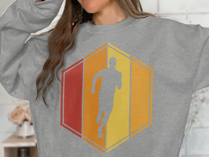 Gray sweatshirt with a distressed hexagon graphic featuring a running silhouette.