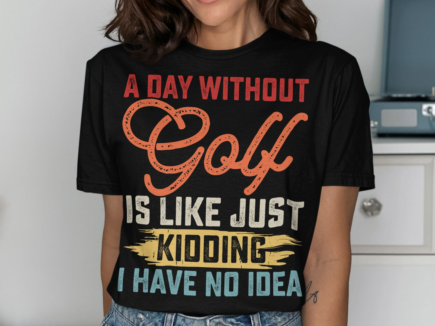 Black t-shirt with "A day without golf is like just kidding no idea" text.