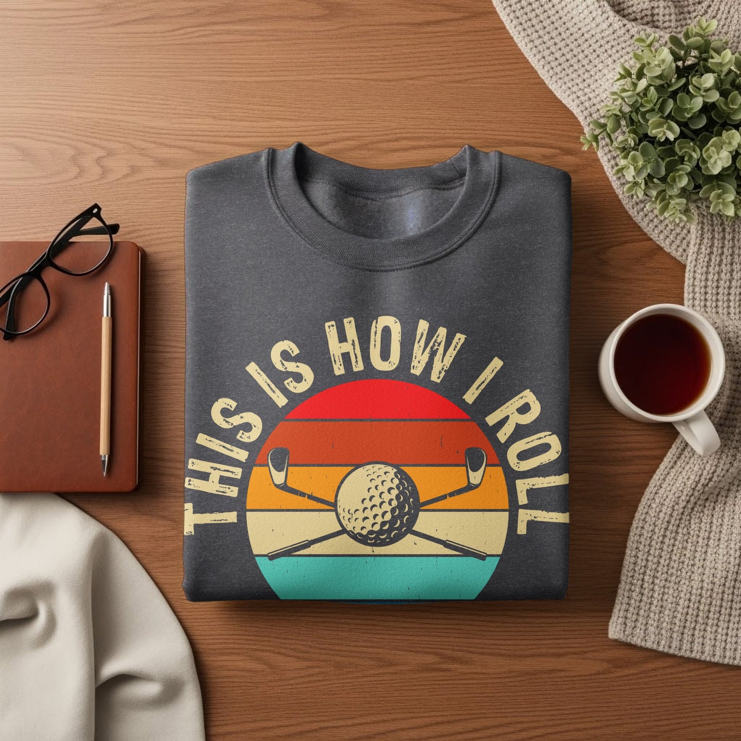 Dark gray sweatshirt with "This is how I roll" text and golf ball and clubs.
