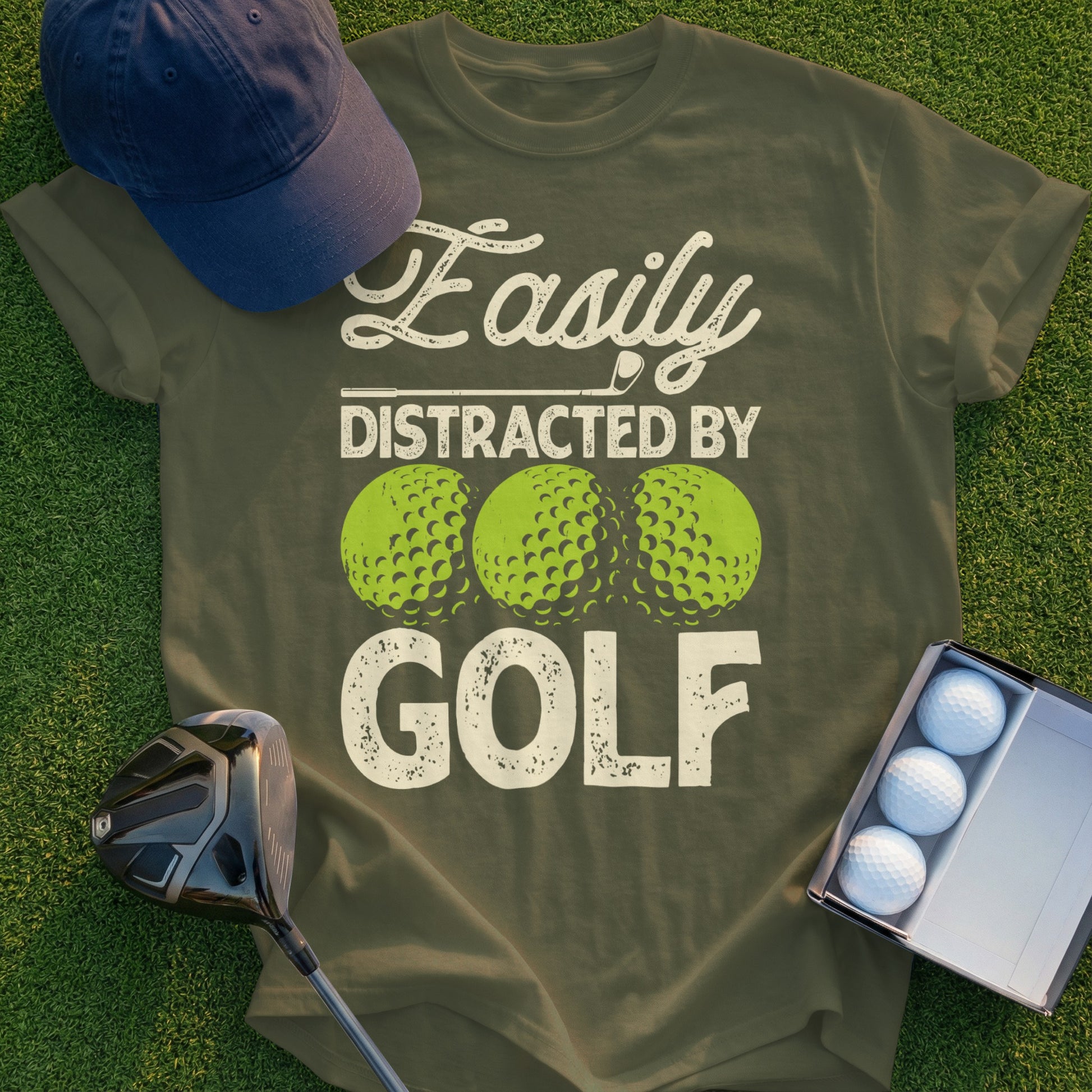 Olive green t-shirt with "Easily Distracted By GOLF" and three golf balls.