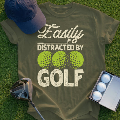 Olive green t-shirt with "Easily Distracted By GOLF" and three golf balls.
