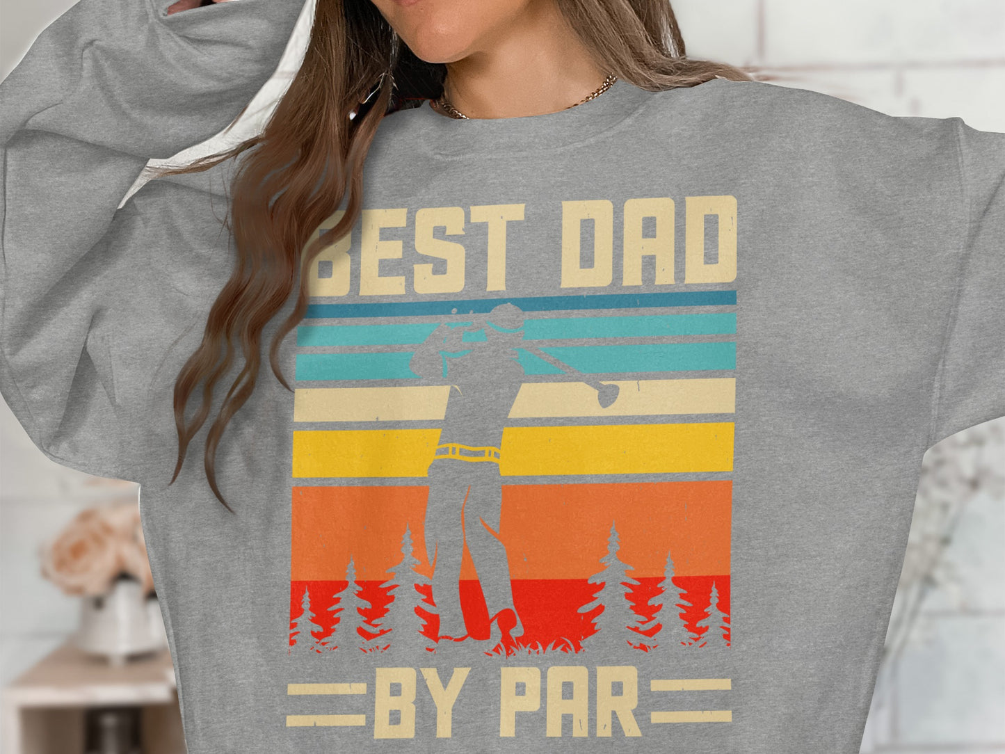 Grey sweatshirt with "BEST DAD BY PAR" text and golfer silhouette over striped background.
