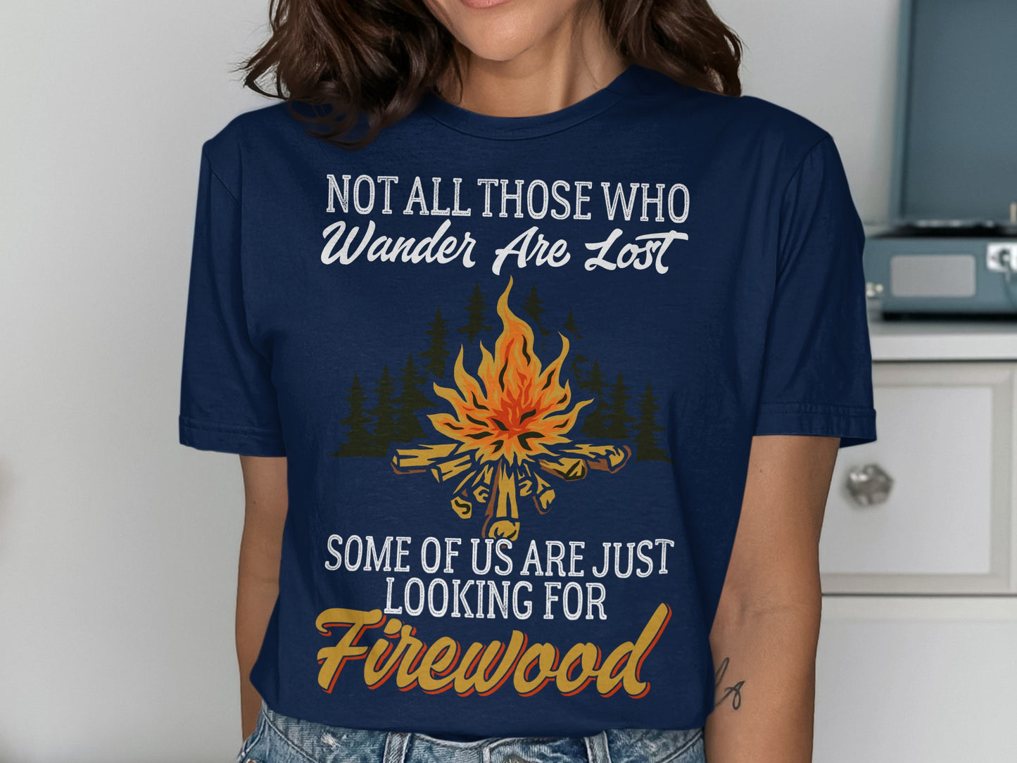 Navy t-shirt with campfire graphic and text "Not all those who wander are lost. Some of us are just looking for Firewood."