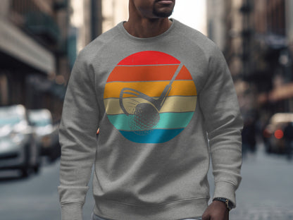Gray sweatshirt with a retro golf club and ball graphic on a street background.