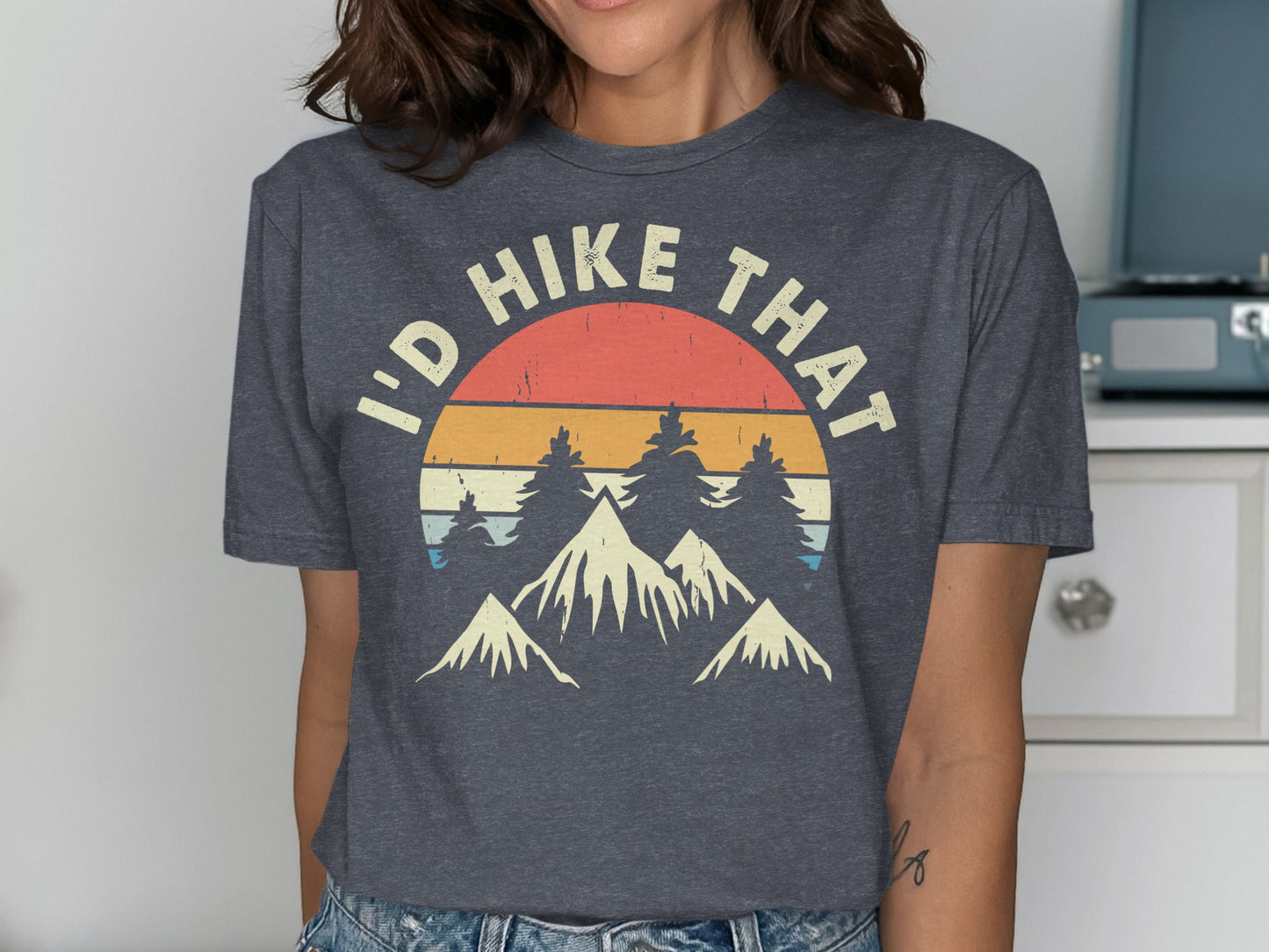 Dark grey t-shirt with "I'd Hike That" text and mountain landscape graphic.