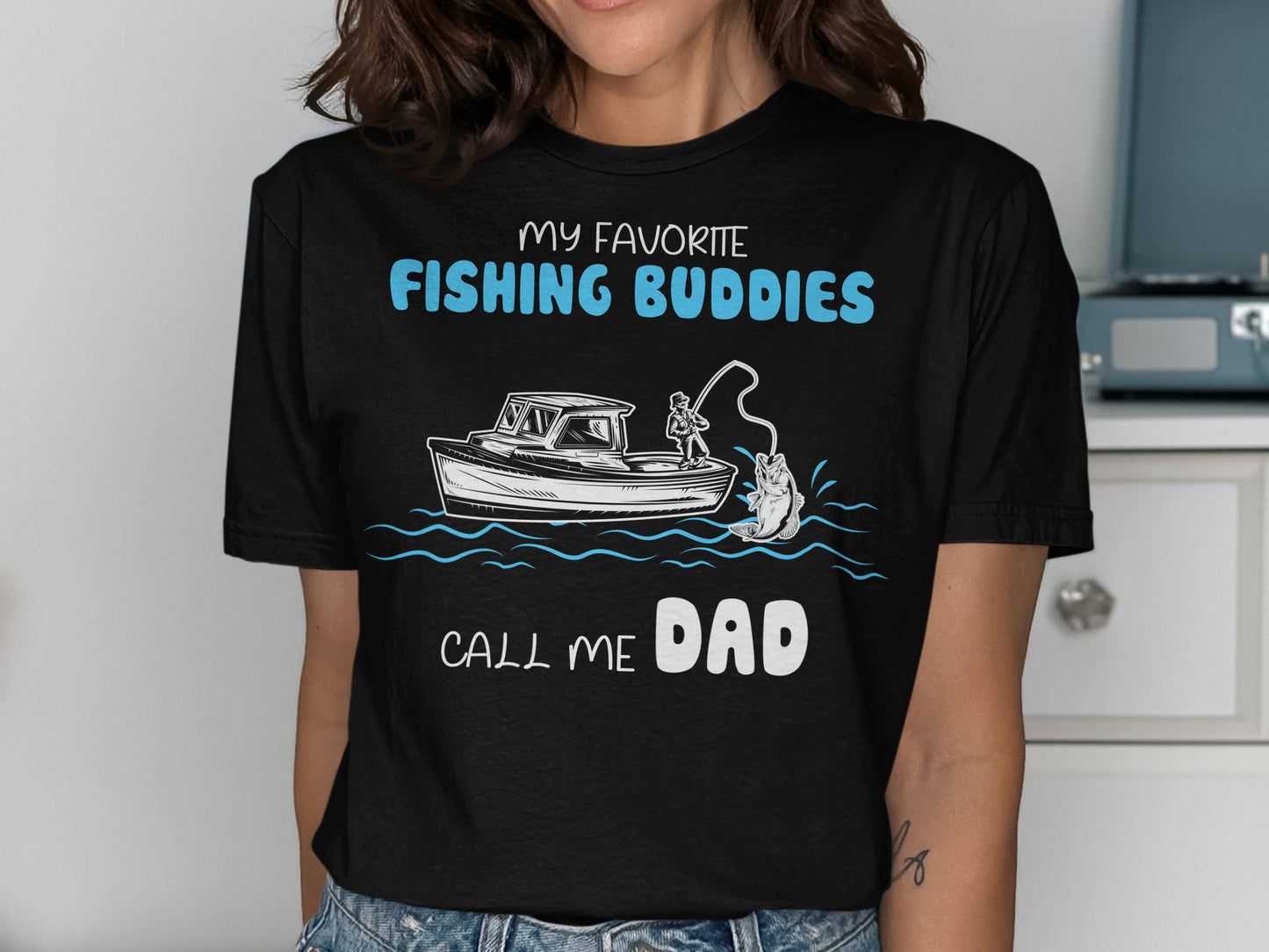 Black t-shirt with "My Favorite Fishing Buddies Call Me Dad" and fishing boat graphic.