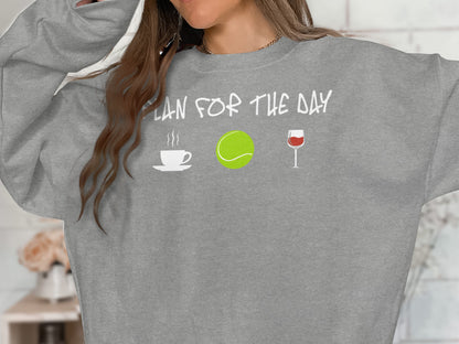Gray sweatshirt with "PLAN FOR THE DAY" text and coffee, tennis, and wine icons.