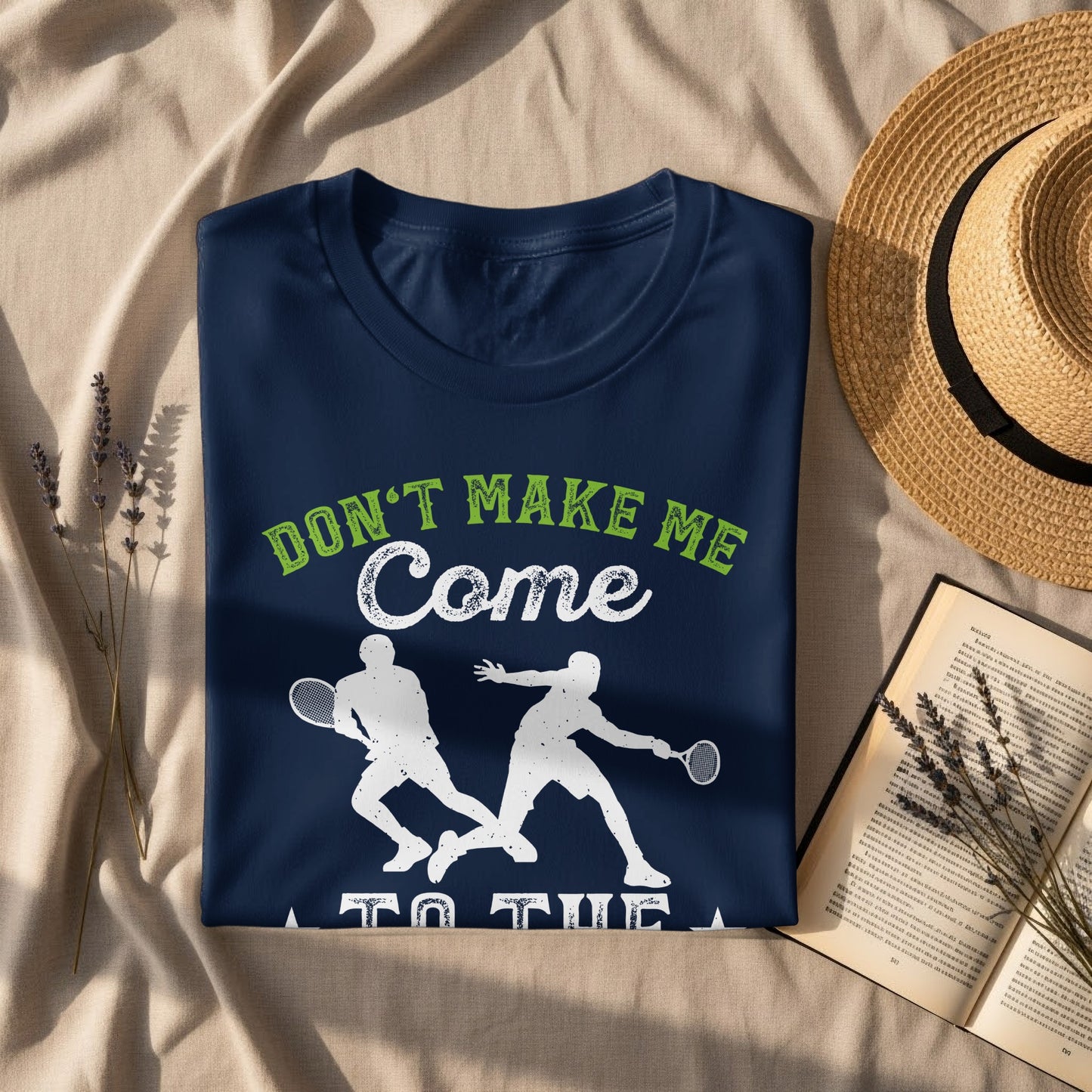 Dark blue t-shirt with white and green graphic saying "Don't Make Me Come To The Court".