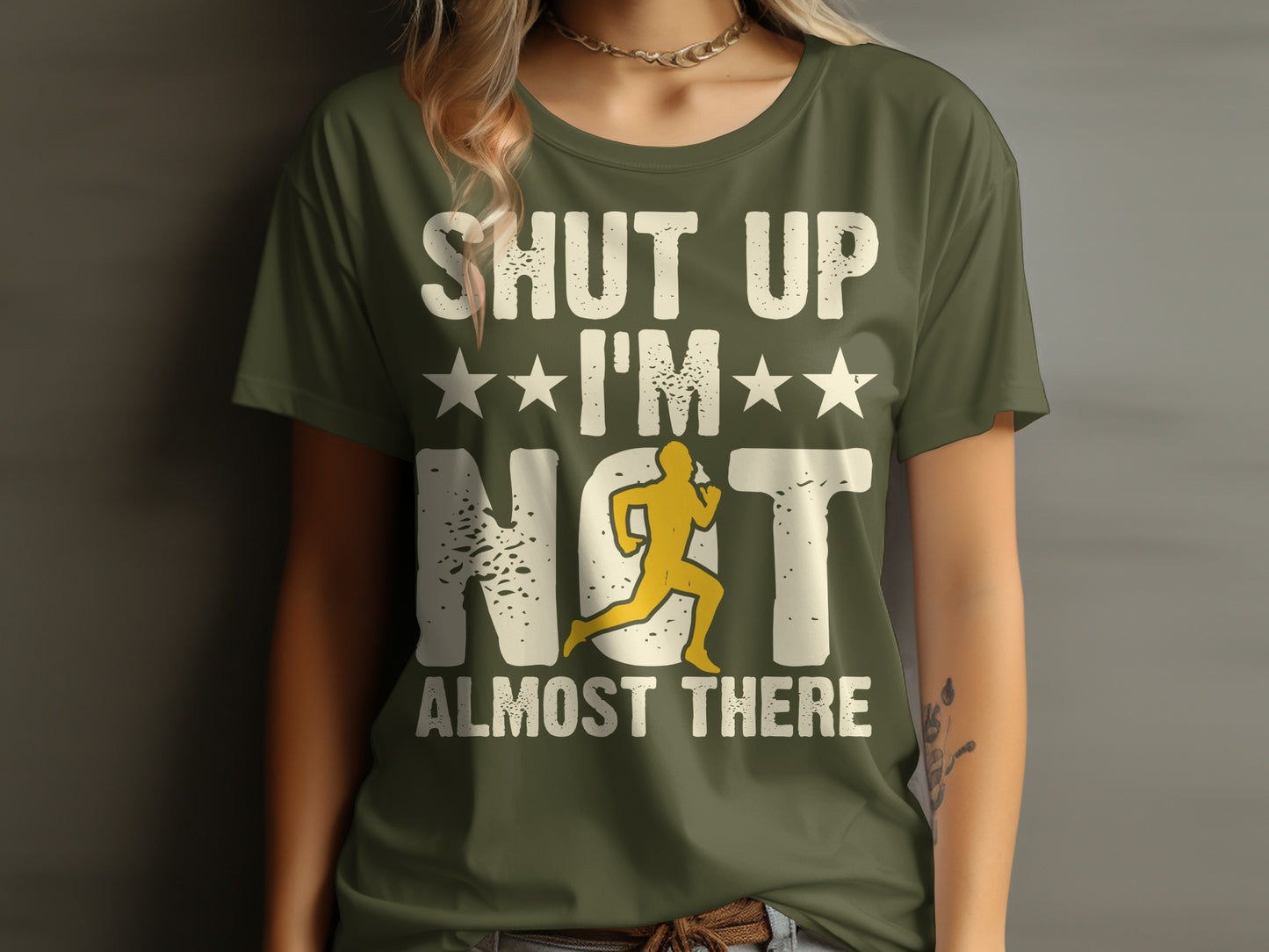 Green t-shirt with white text "Shut up, I'm almost there" and runner graphic.