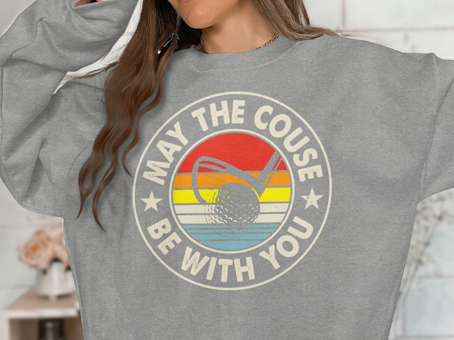 Gray sweatshirt with "May the couse be with you" text and golf ball graphic.