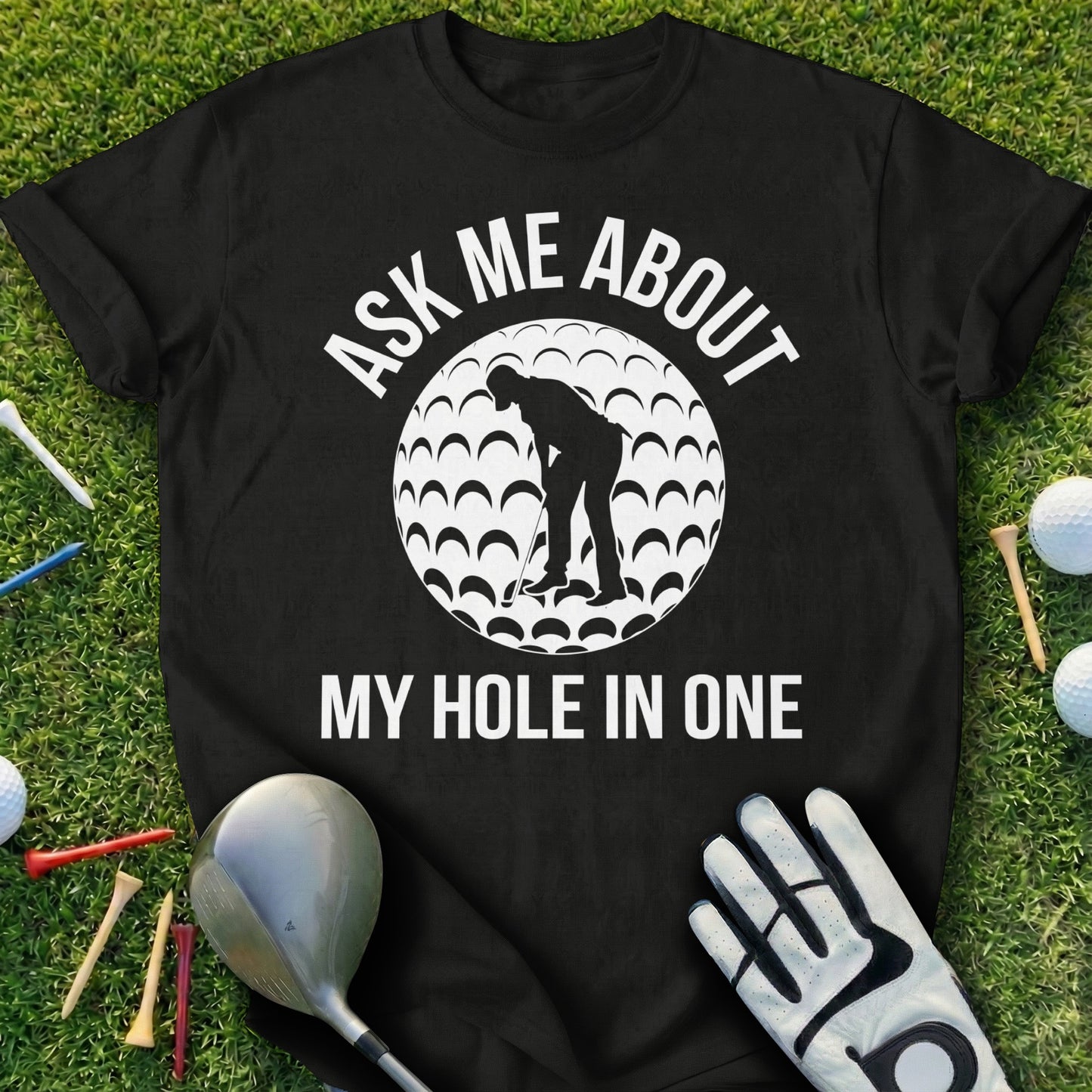 Black t-shirt with "Ask Me About My Hole In One" and a golfer graphic.