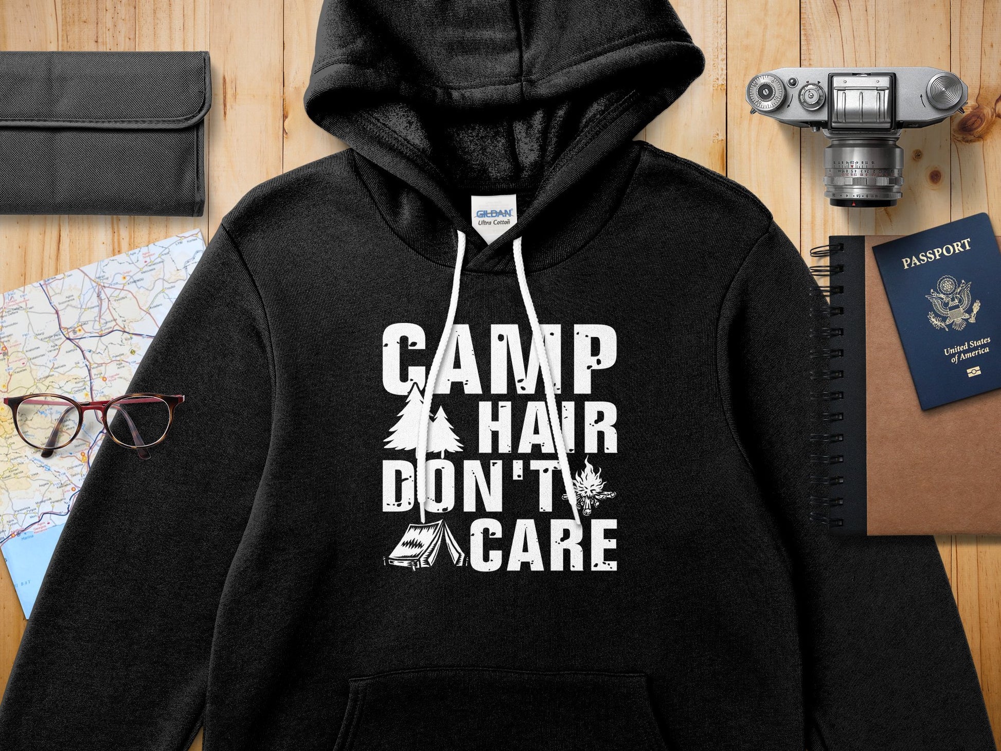 Black Gildan hoodie with "CAMP HAIR DON'T CARE" graphic.