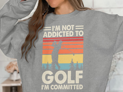 Grey sweatshirt with vintage sunset golf graphic and text.