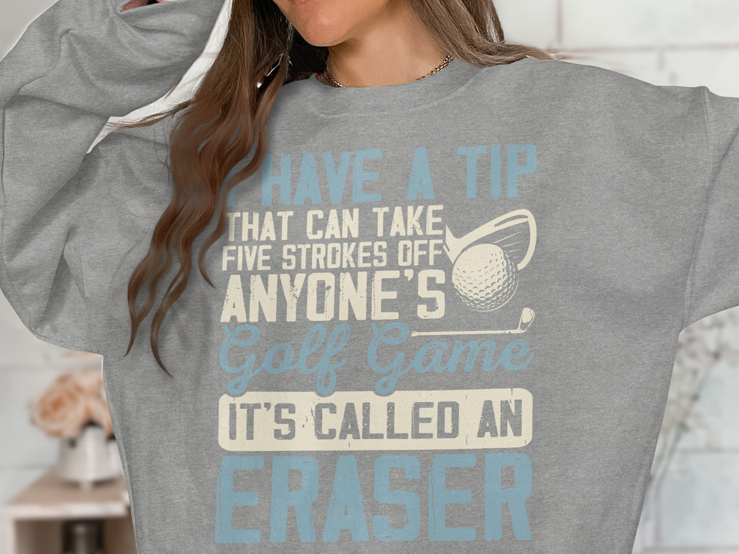 Sweatshirt with text "Have a tip that can take five strokes off anyone's golf game. It's called an eraser."