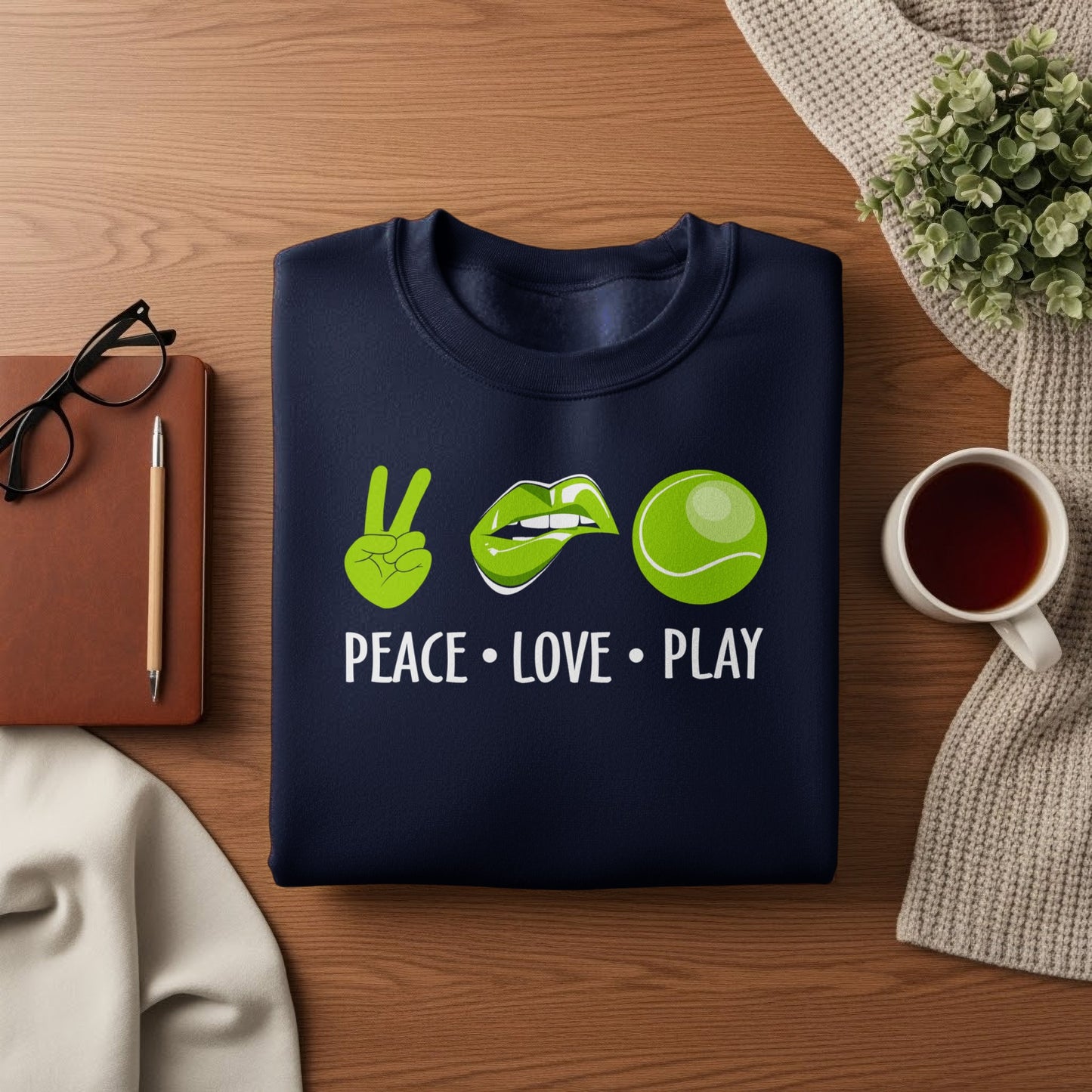 Navy sweatshirt with "Peace Love Play" text, peace sign, lips, and tennis ball design.