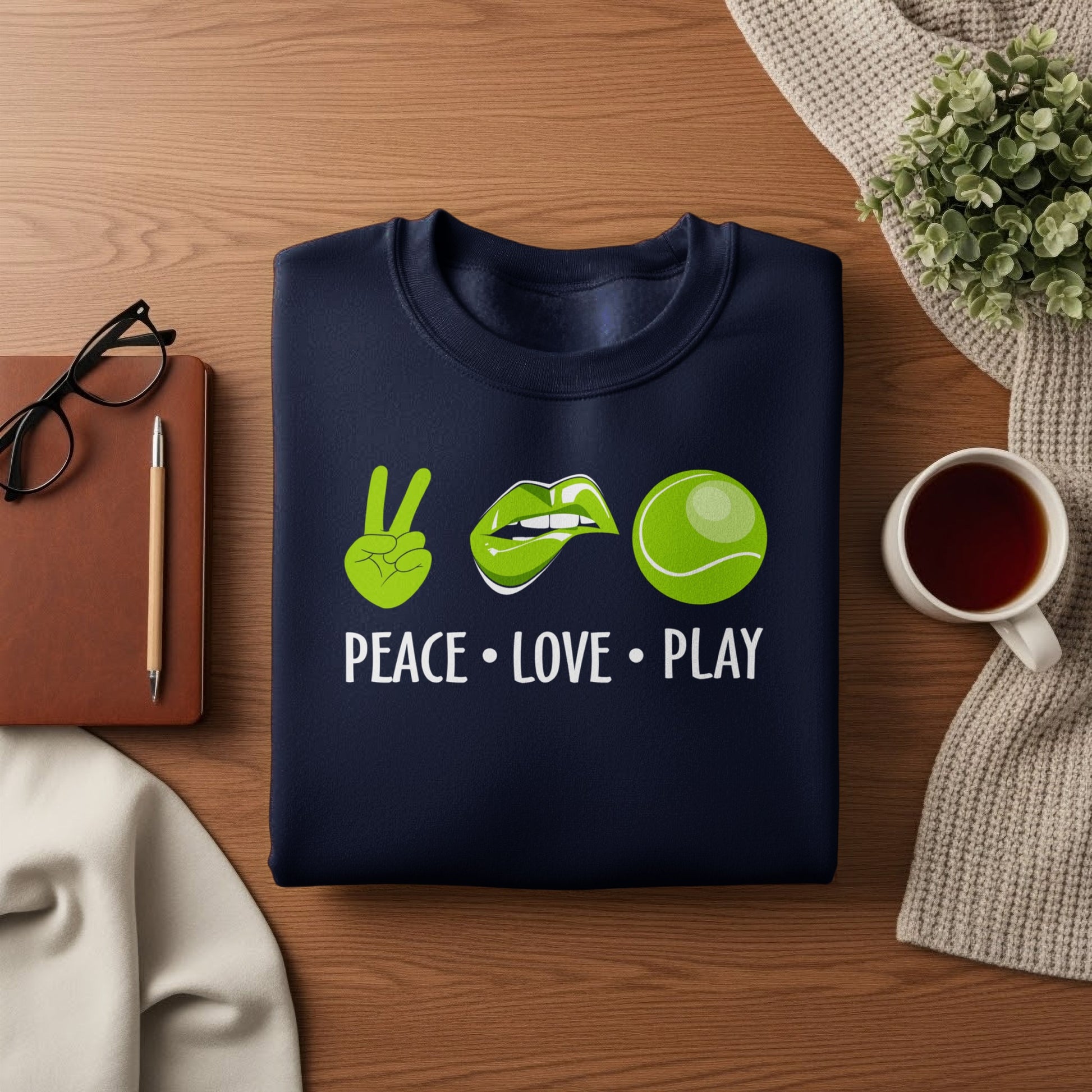 Navy sweatshirt with "Peace Love Play" text, peace sign, lips, and tennis ball design.