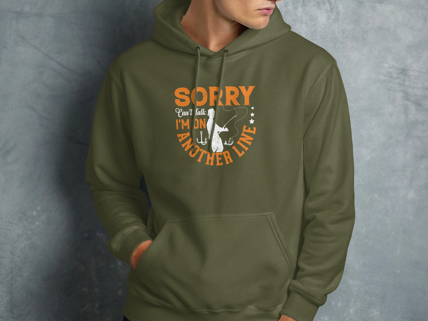 Olive hoodie with "Sorry, can't talk, I'm on another line" fishing graphic.