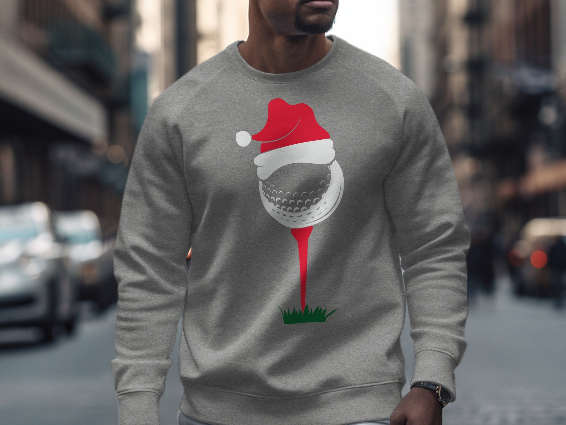 Gray sweatshirt with a graphic of a golf ball wearing a Santa hat on a tee.