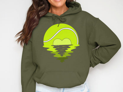 Green hoodie with a tennis ball sunrise graphic and water reflection.
