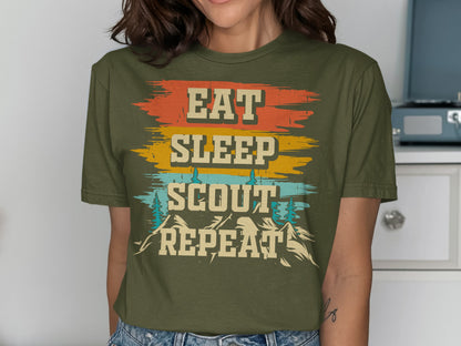 Olive green t-shirt with "EAT SLEEP SCOUT REPEAT" text and mountain graphics.