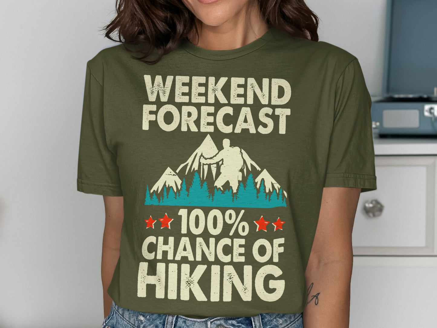 Olive green t-shirt with "Weekend Forecast 100% Chance of Hiking" text and mountain graphic.