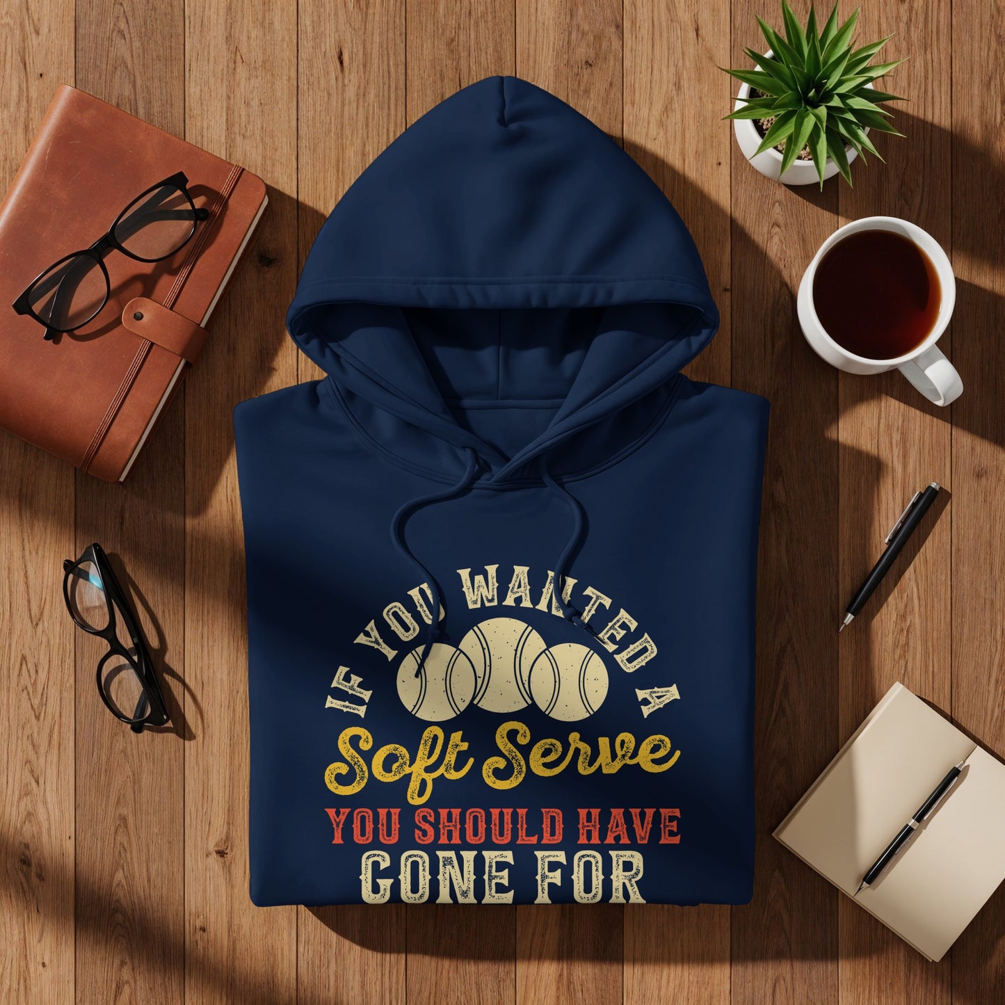 Navy blue hoodie with text and tennis balls graphic.