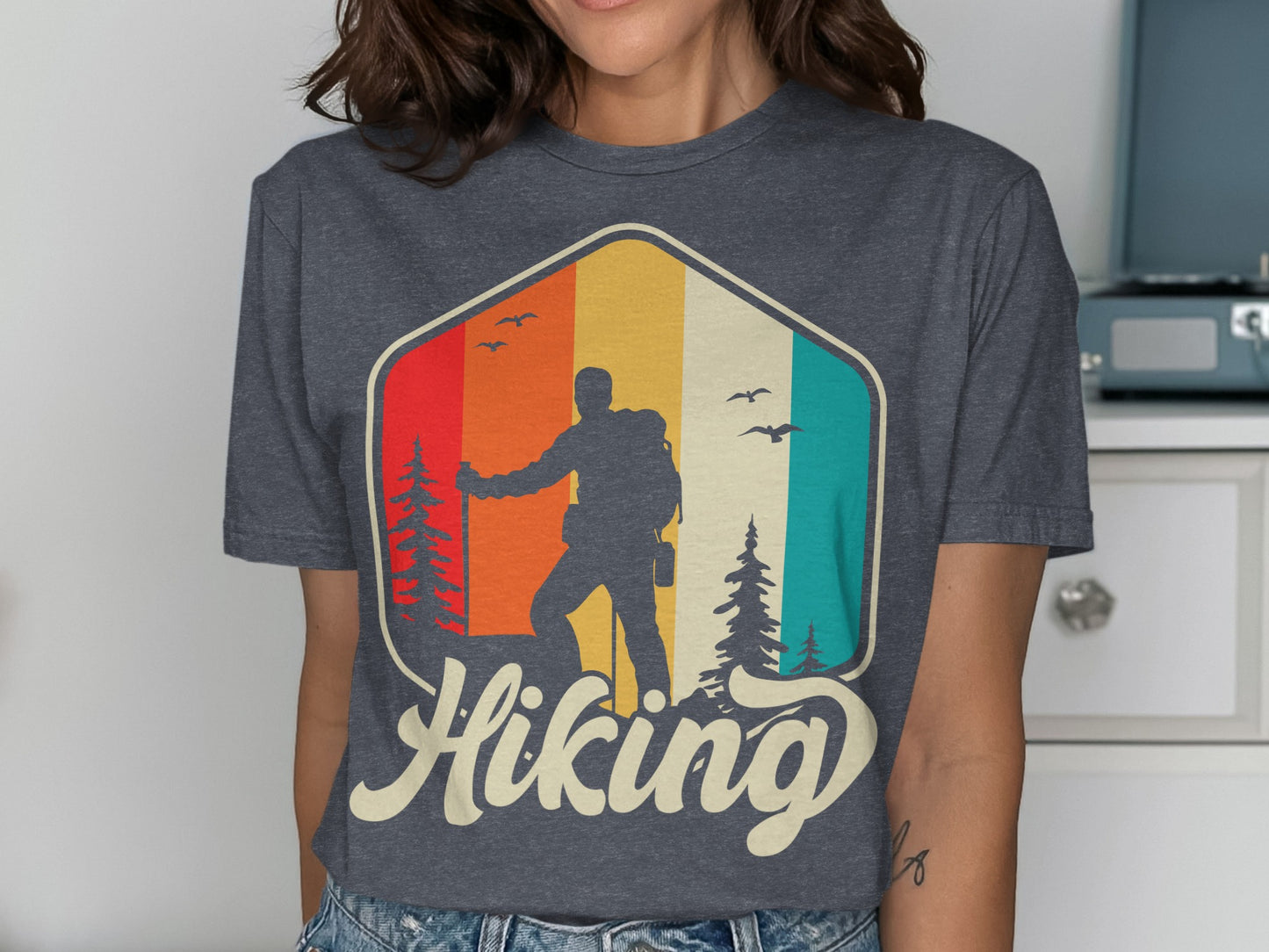T-shirt graphic of a hiker with colorful stripes and "Hiking" text.