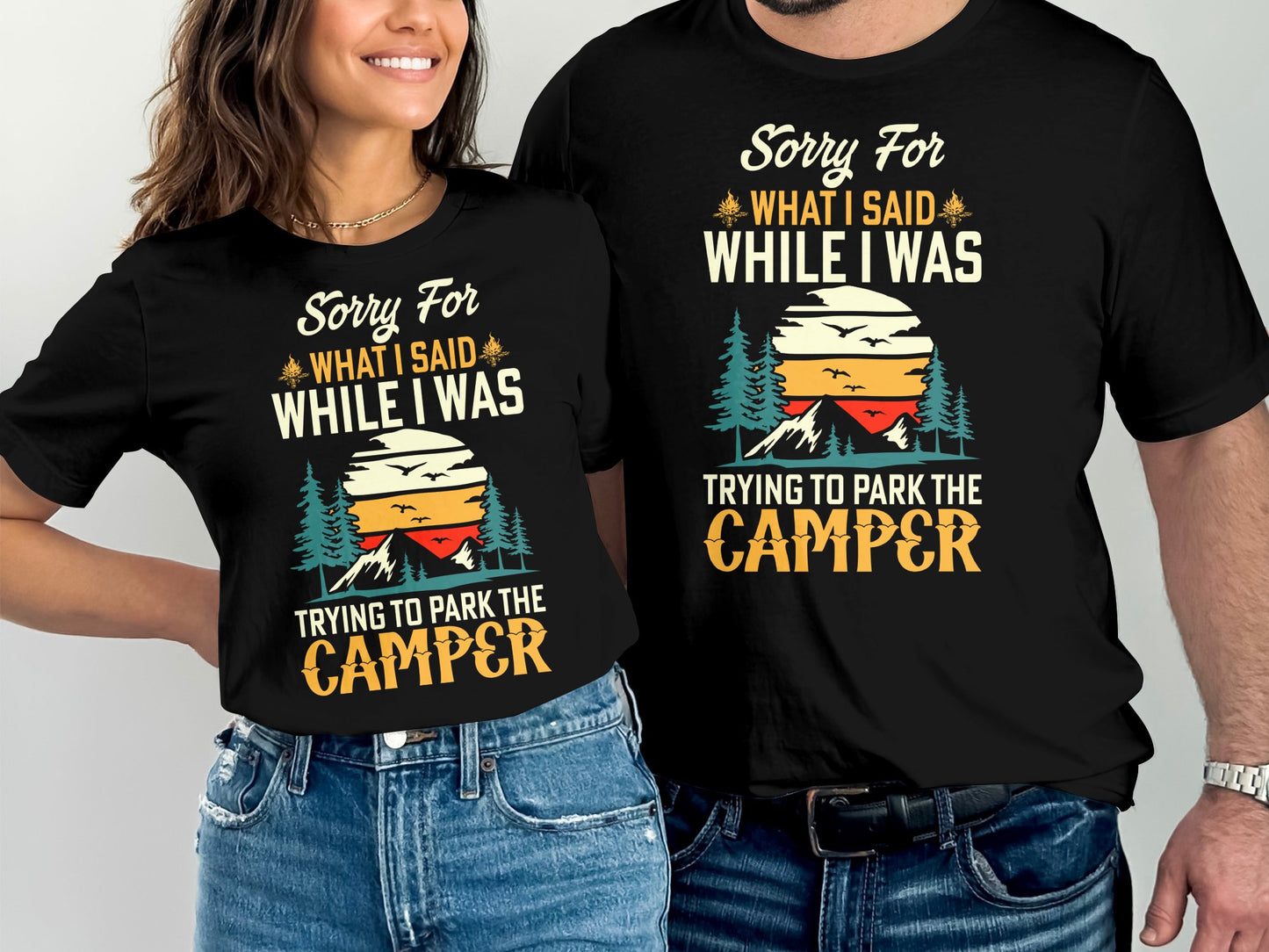 Black t-shirts with "Sorry For What I Said While Trying to Park the Camper" text and mountain graphic.