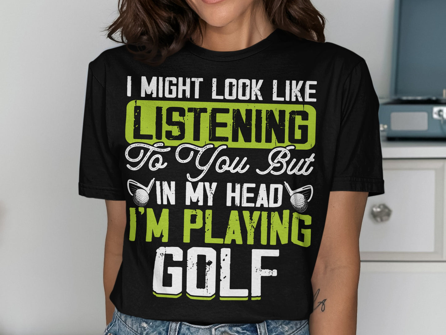 Black t-shirt with text "I might look like I'm listening to you but in my head I'm playing golf."