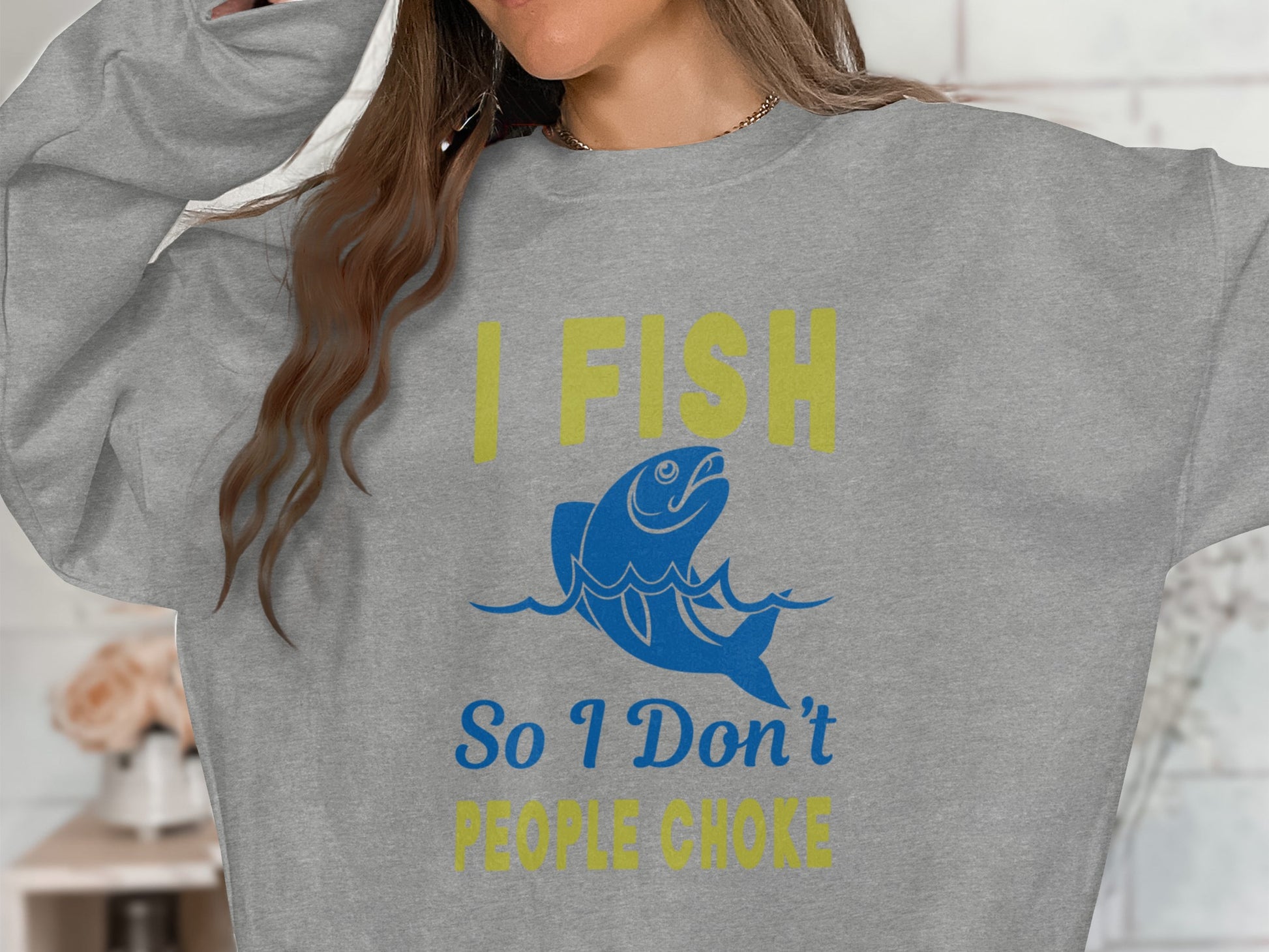 Grey sweatshirt with yellow text "I FISH" and blue fish graphic.