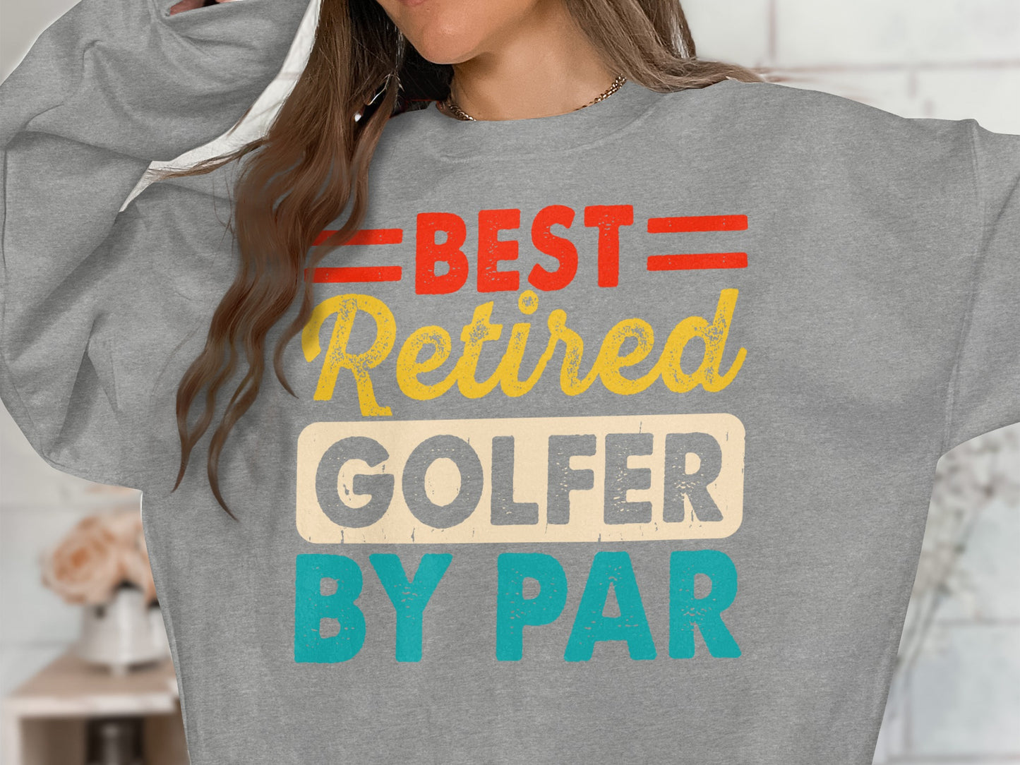 Grey sweatshirt with "BEST RETIRED GOLFER BY PAR" in red, yellow, and blue text.