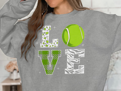 Gray sweatshirt with "LOVE" text, tennis ball, and patterned letters.