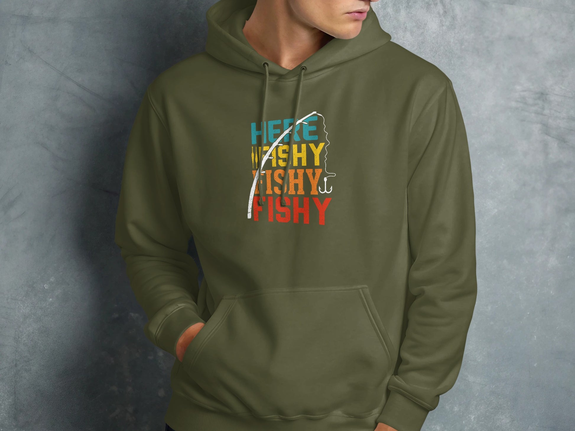 Olive green hoodie with colorful "here washy fishy fishy" text and fishing hook graphic.