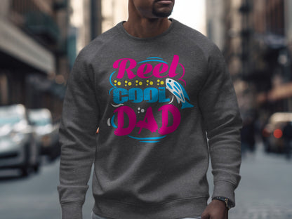Gray crewneck sweatshirt with "Reel Cool Dad" text and fish graphic.