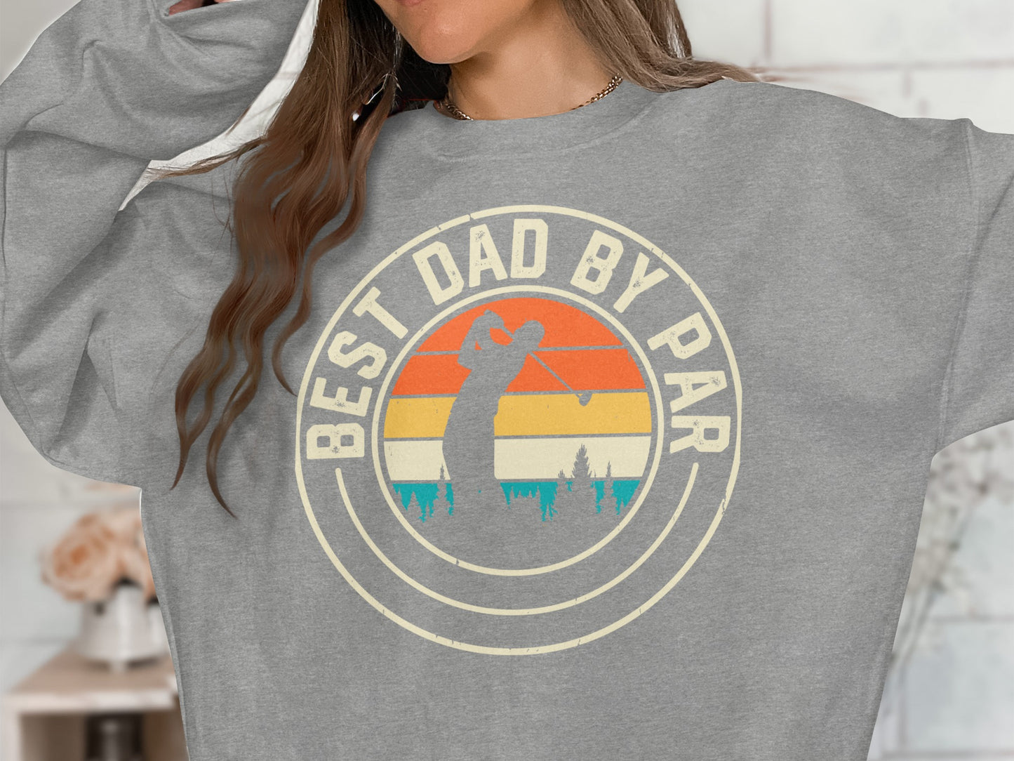 Sweatshirt with "BEST DAD BY PAR" text and vintage golfer graphic.