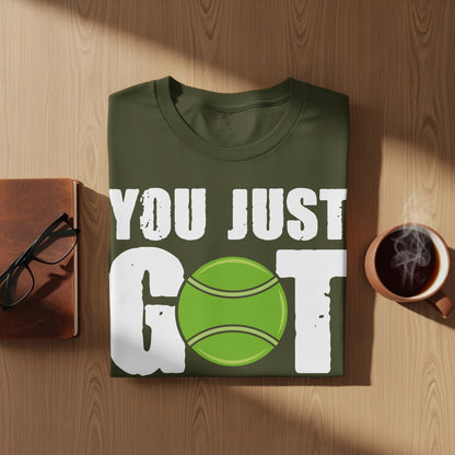 Olive t-shirt with "YOU JUST GOT" text and a green tennis ball graphic.