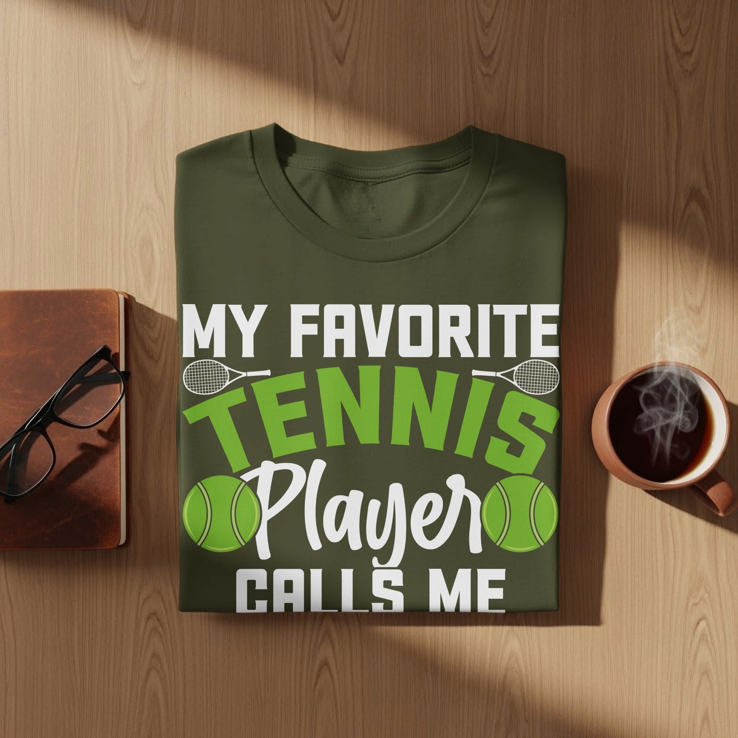 Olive green t-shirt with "My Favorite Tennis Player Calls Me" text.