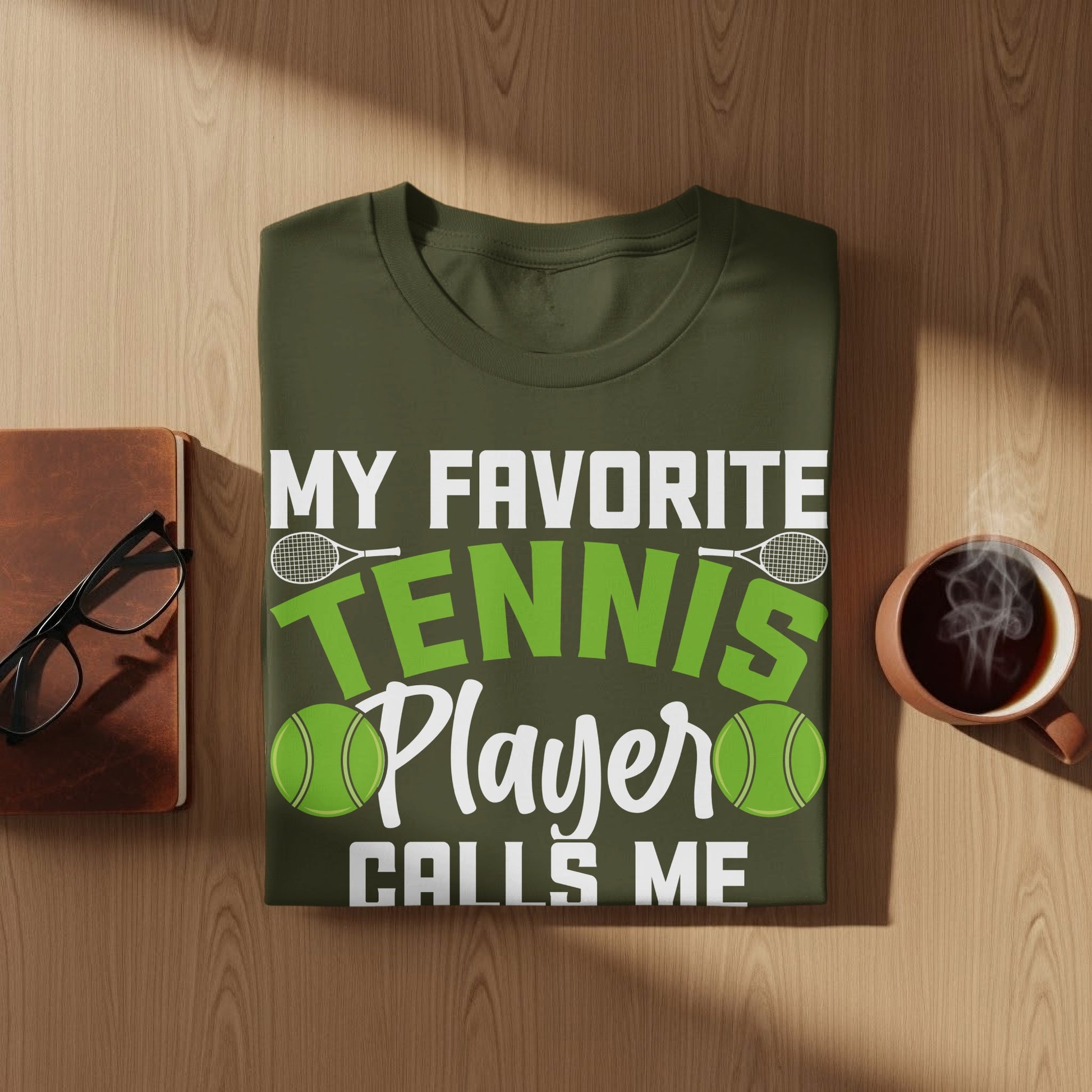 Olive green t-shirt with "My Favorite Tennis Player Calls Me" text.
