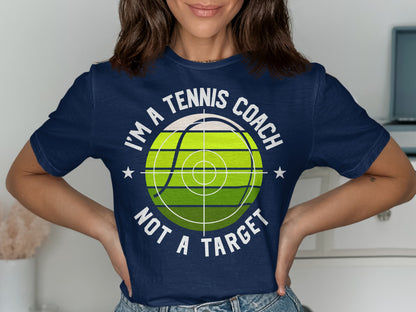 Navy t-shirt with "I'm a tennis coach not a target" and tennis ball graphic.