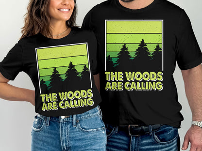 Couple wearing black t-shirts with "The Woods Are Calling" forest design.