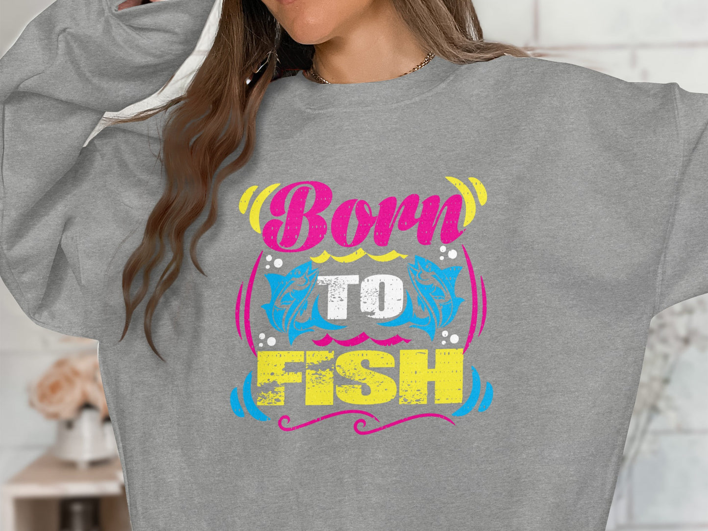 Gray sweatshirt with "Born to FISH" text and blue fish graphic.