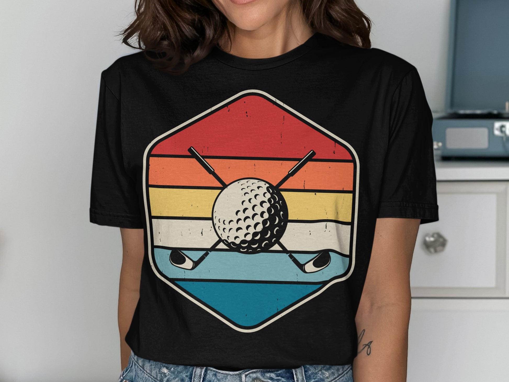 Retro golf ball and crossed clubs within a hexagonal design.