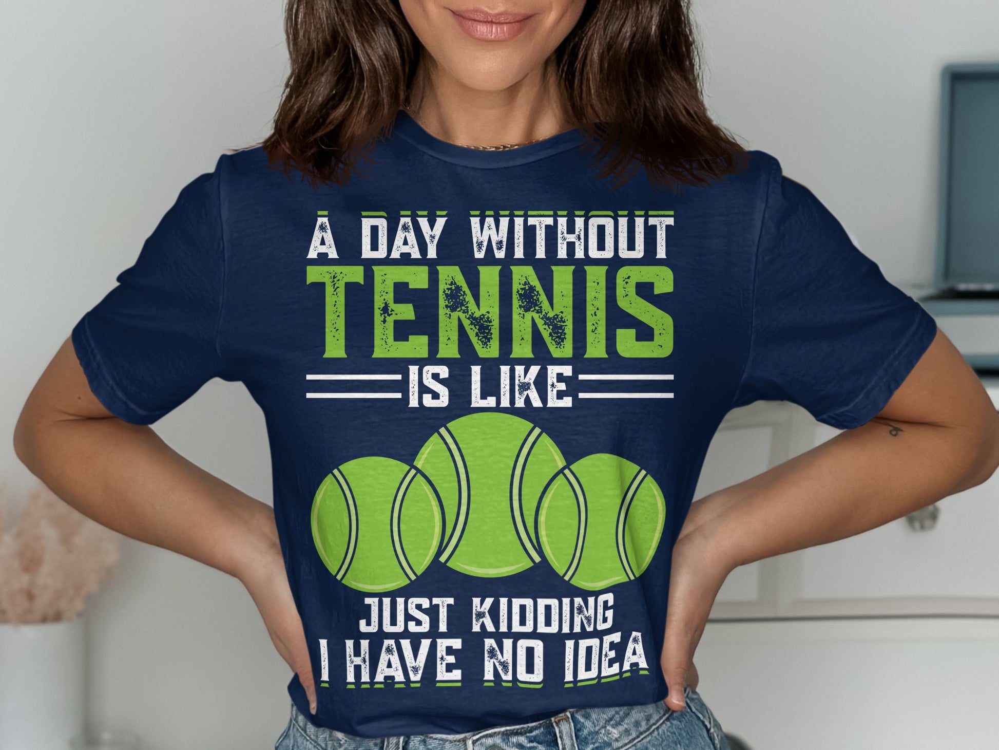 Navy t-shirt with "A Day Without Tennis Is Like... Just Kidding I Have No Idea" and tennis balls.