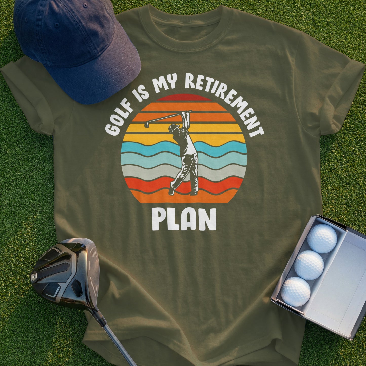 Olive green t-shirt with "Golf is my retirement plan" and golfer graphic.