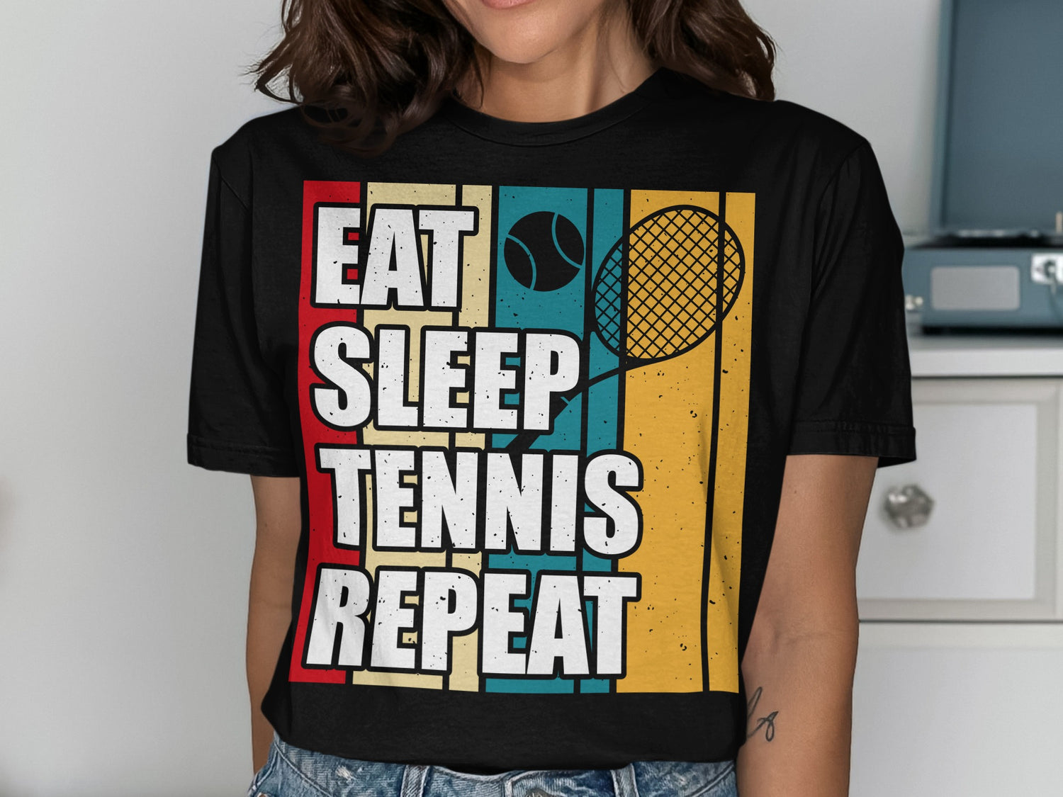 T-shirt with "EAT SLEEP TENNIS REPEAT" text and tennis racket graphic.