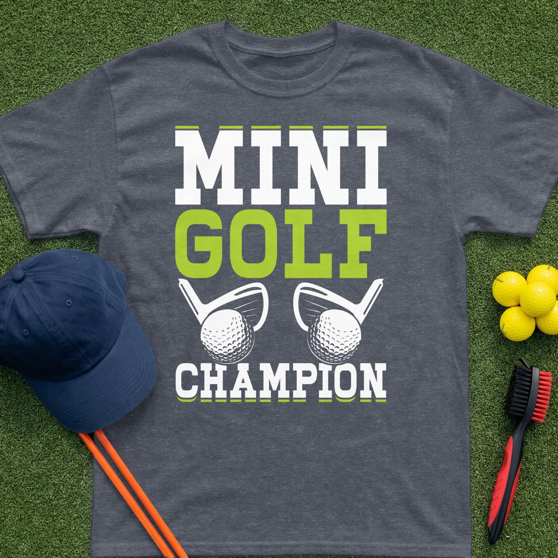 Dark grey t-shirt with "MINI GOLF CHAMPION" text and golf graphics.