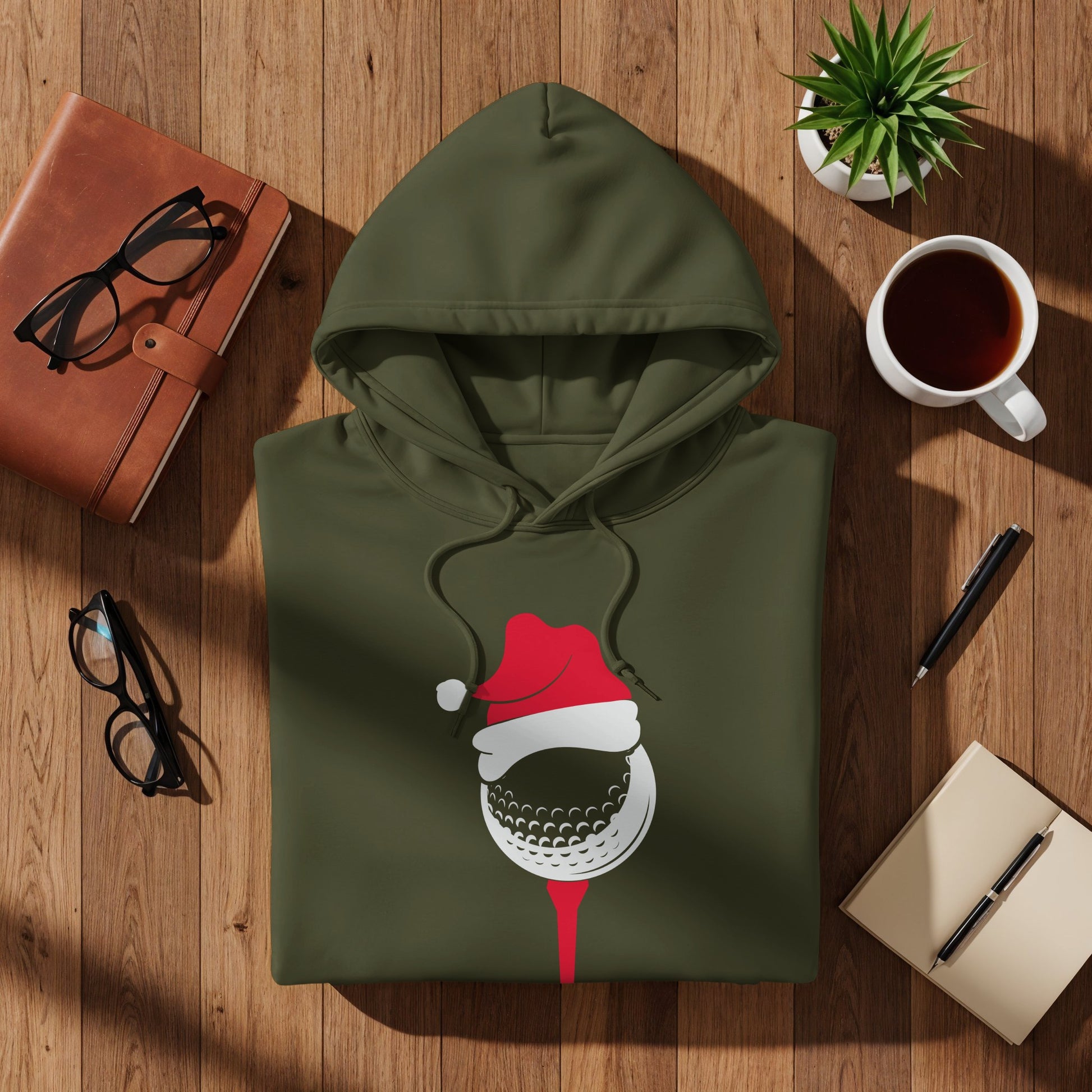 Olive green hoodie with a golf ball wearing a Santa hat graphic.